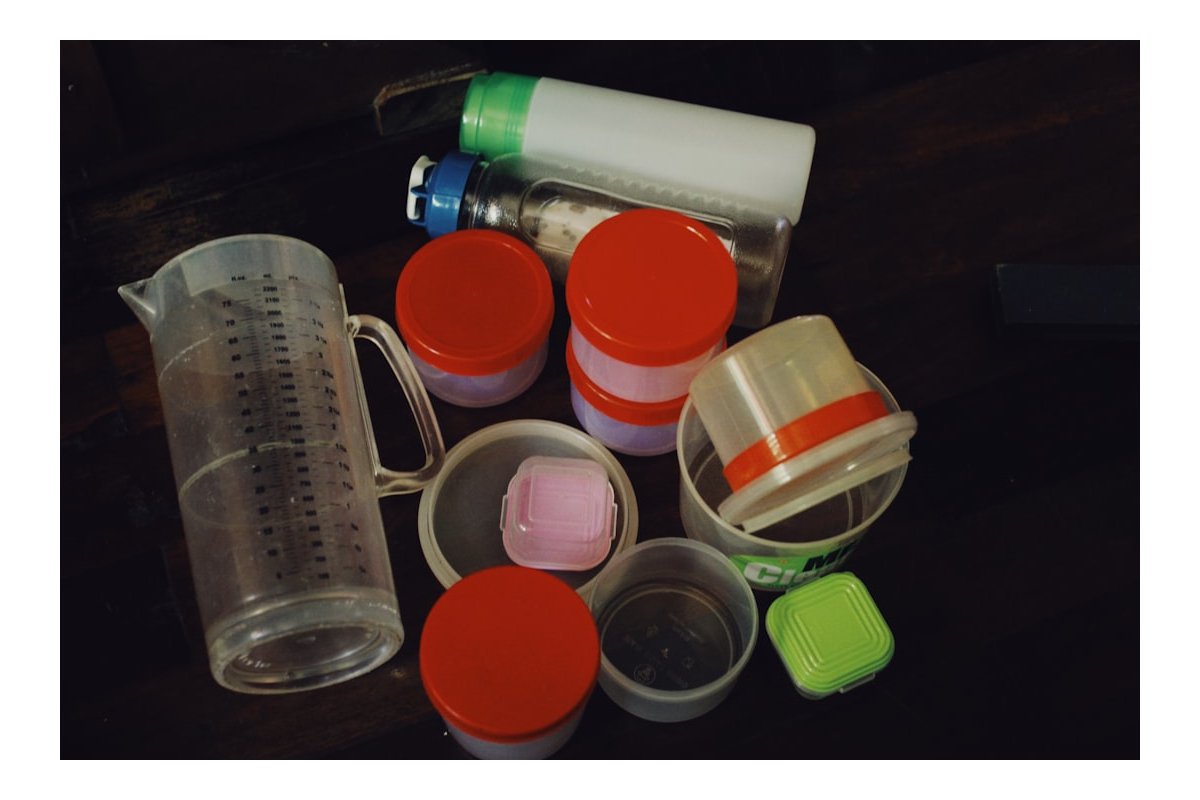 a table topped with plastic containers and containers