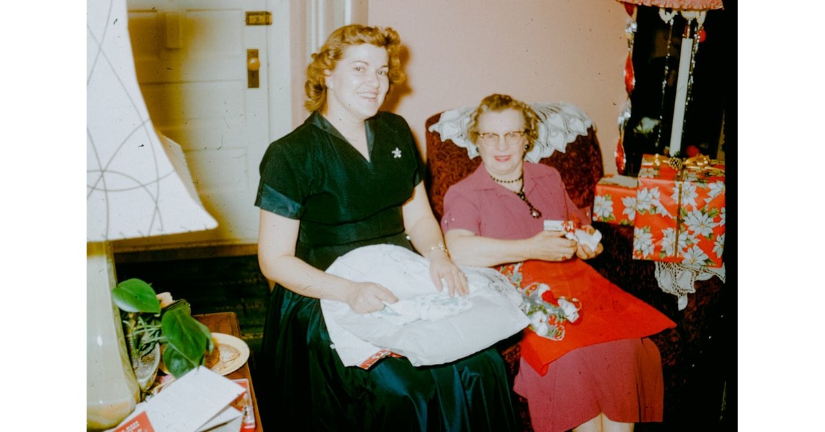 Two women sitting in chairs with gifts